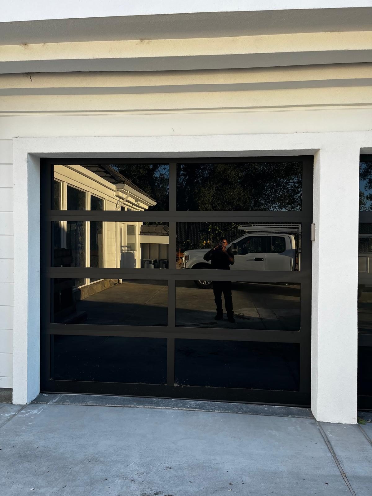 Black aluminum full-view glass garage door installation