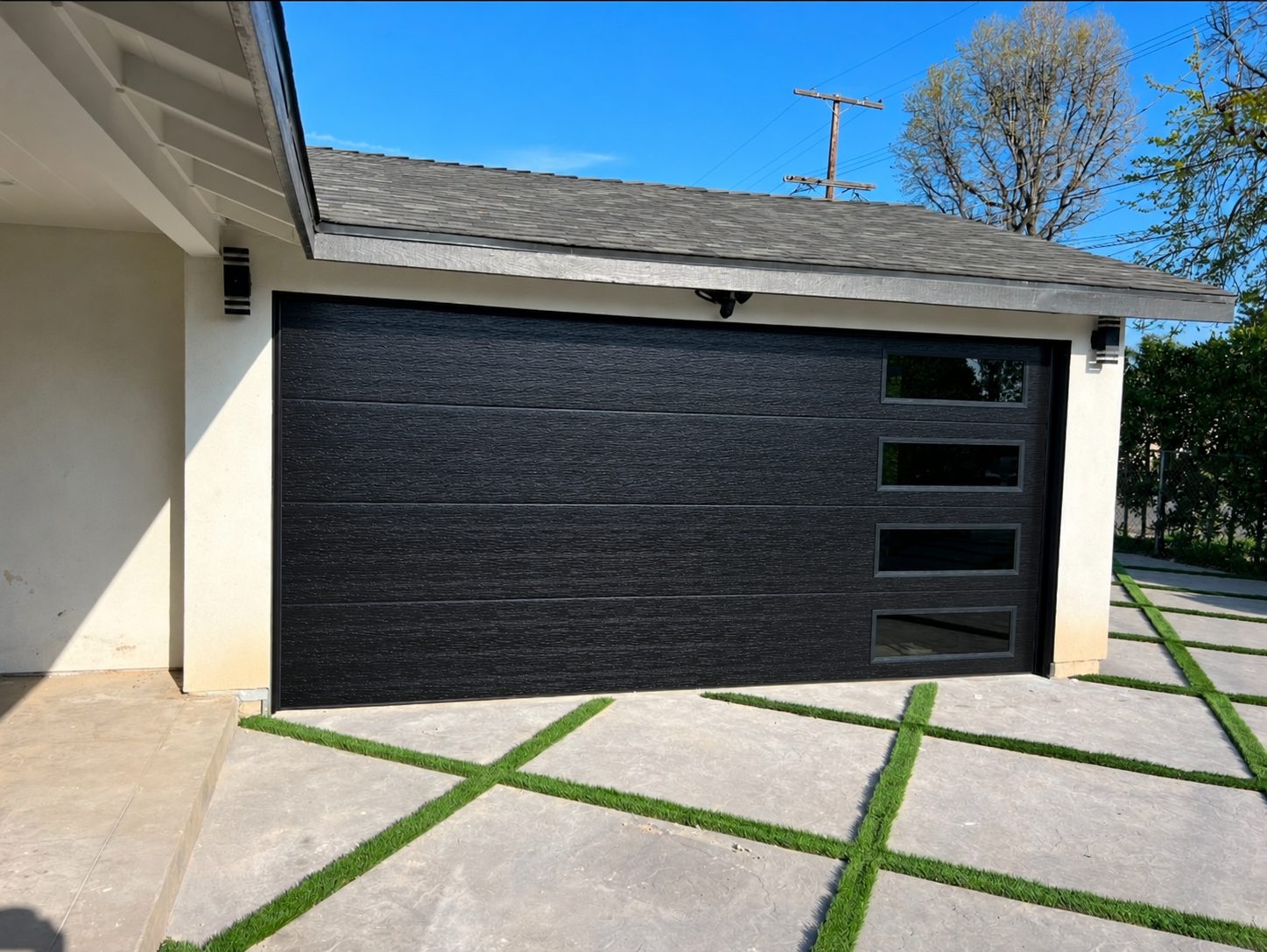 Black modern flush garage door with vertical side windows installed by Perfect Solutions