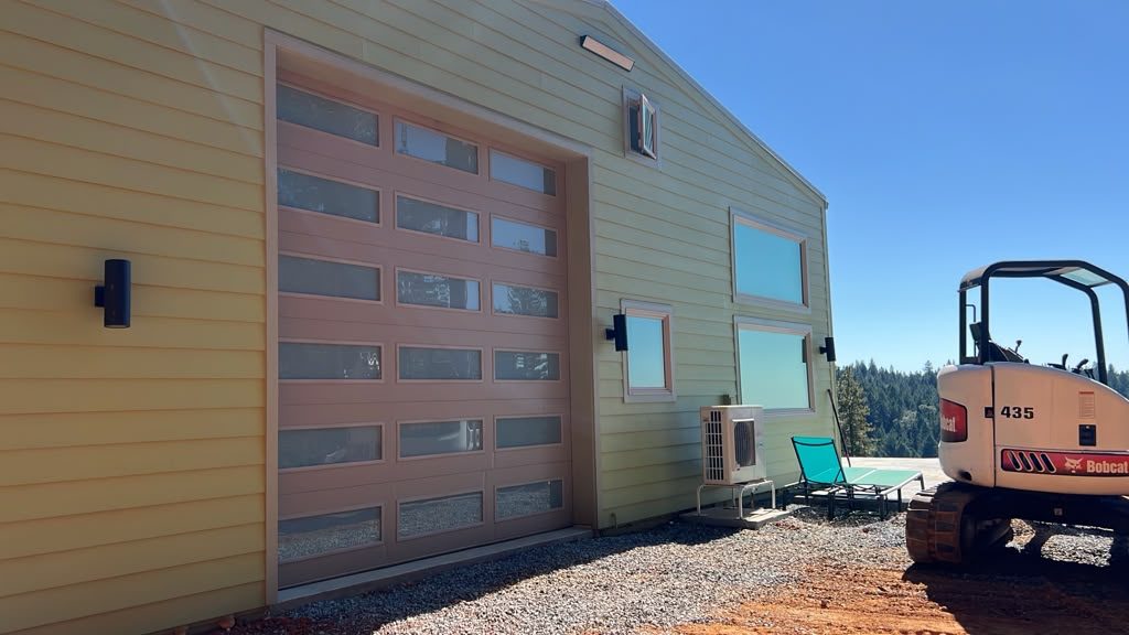 Tall modern woodgrain garage door with frosted glass rows