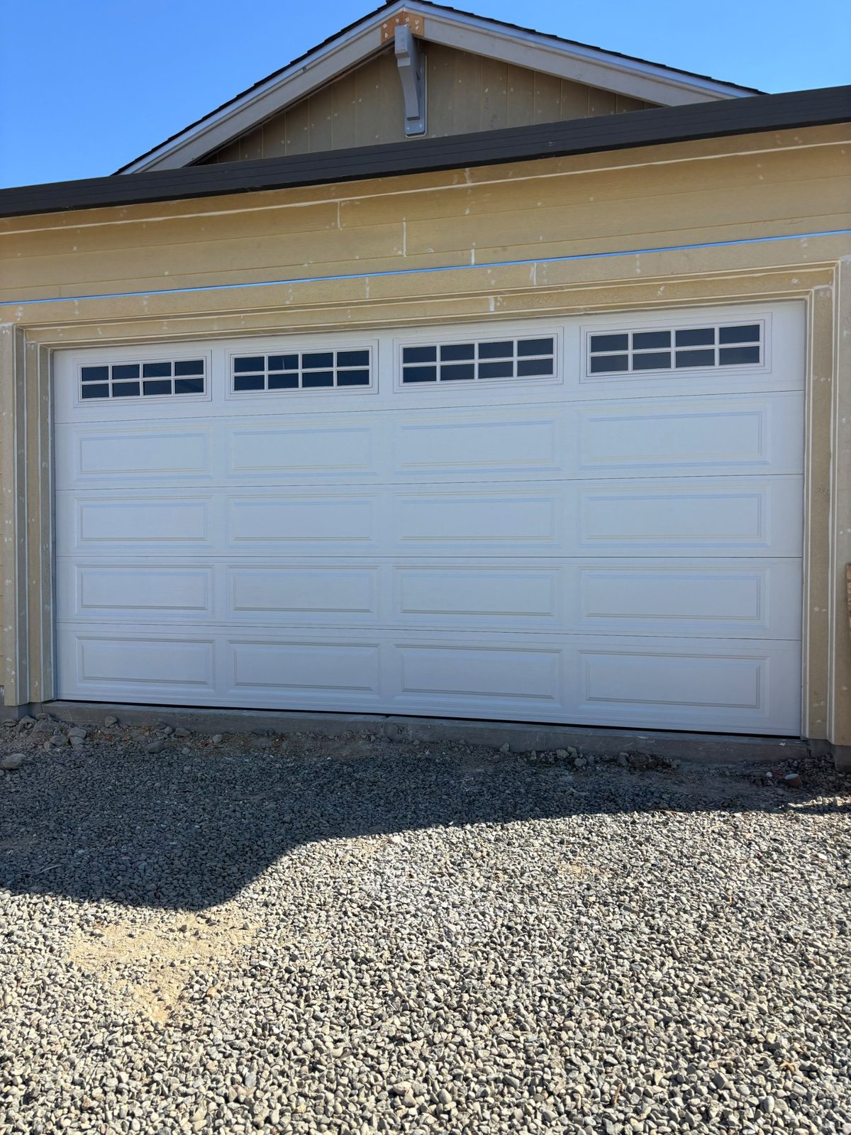 White garage door with long windows on a new home