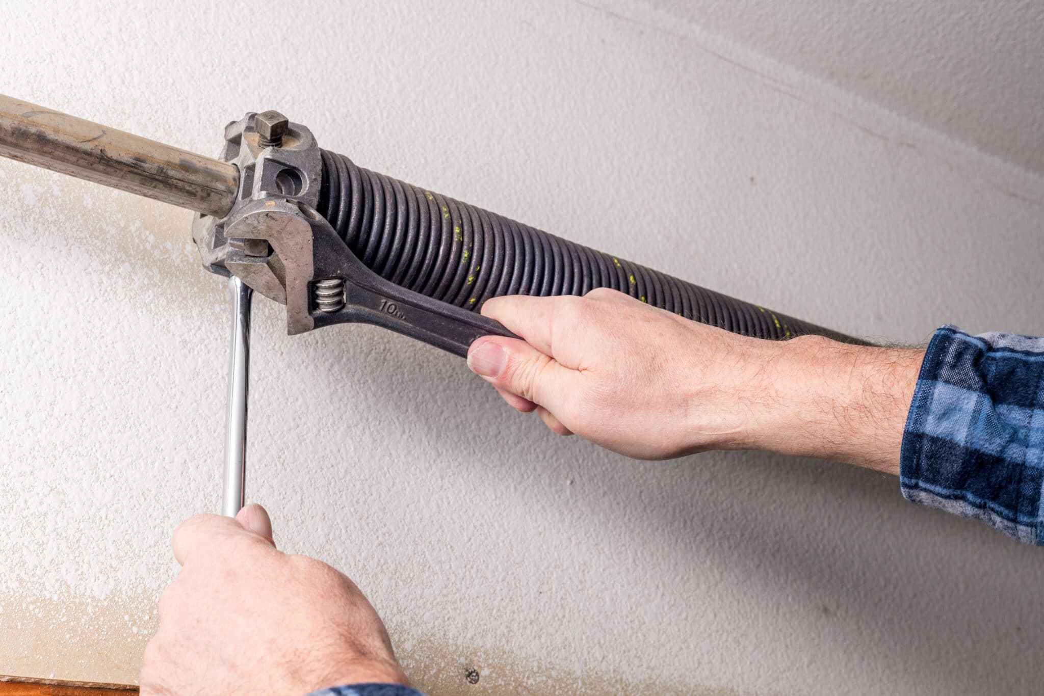 A garage door with a spring Maintenance Checking