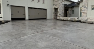 "Stamped concrete driveway with garage doors."