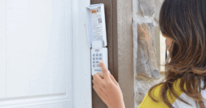 Woman enters garage code on keypad panel.